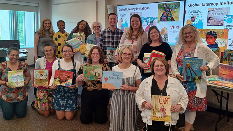 Group of teachers with children's books