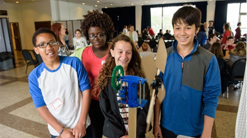 Students posing with their science project