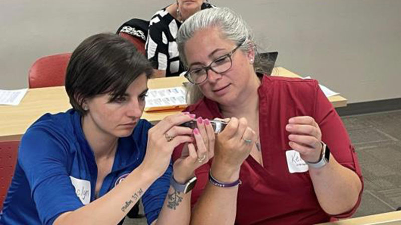 Two participants at a table conducting an experiment