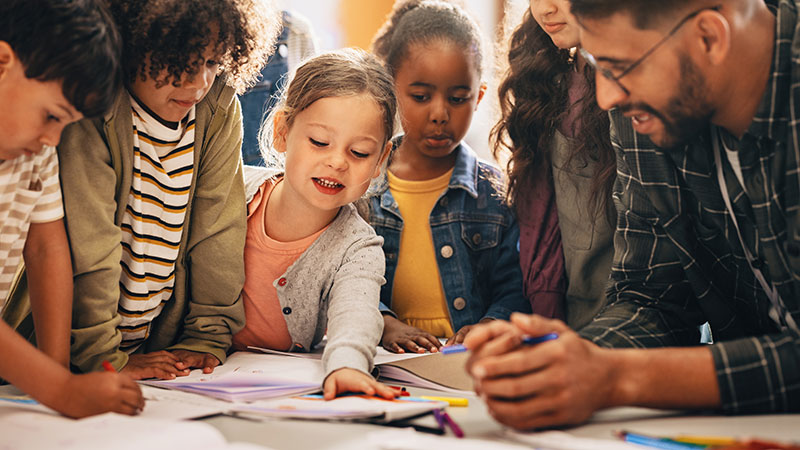 Teacher working on project with elementary school students