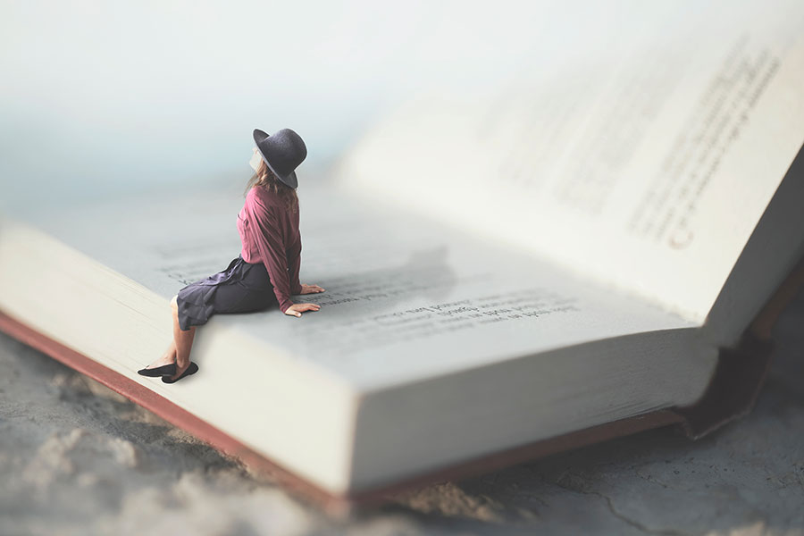 Woman sitting on book page