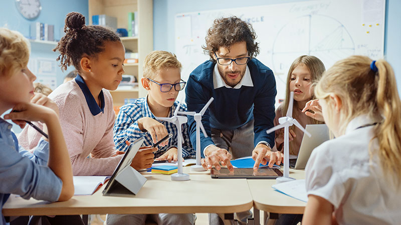 Teacher doing hands-on activity with students