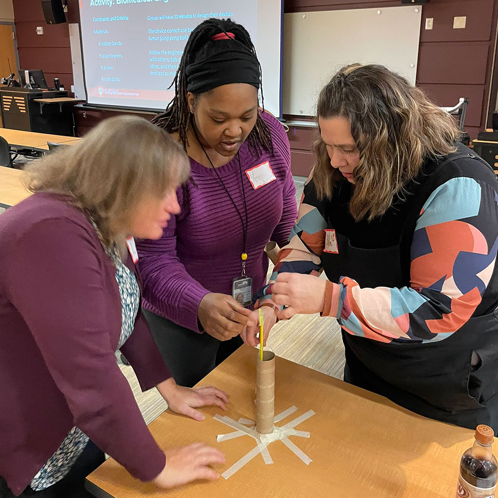 Teachers in the Educational Pathways to Cancer Research project work on a science experiment